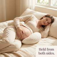 Held from both sides — resting with the Tendra support pillow under bump and behind back